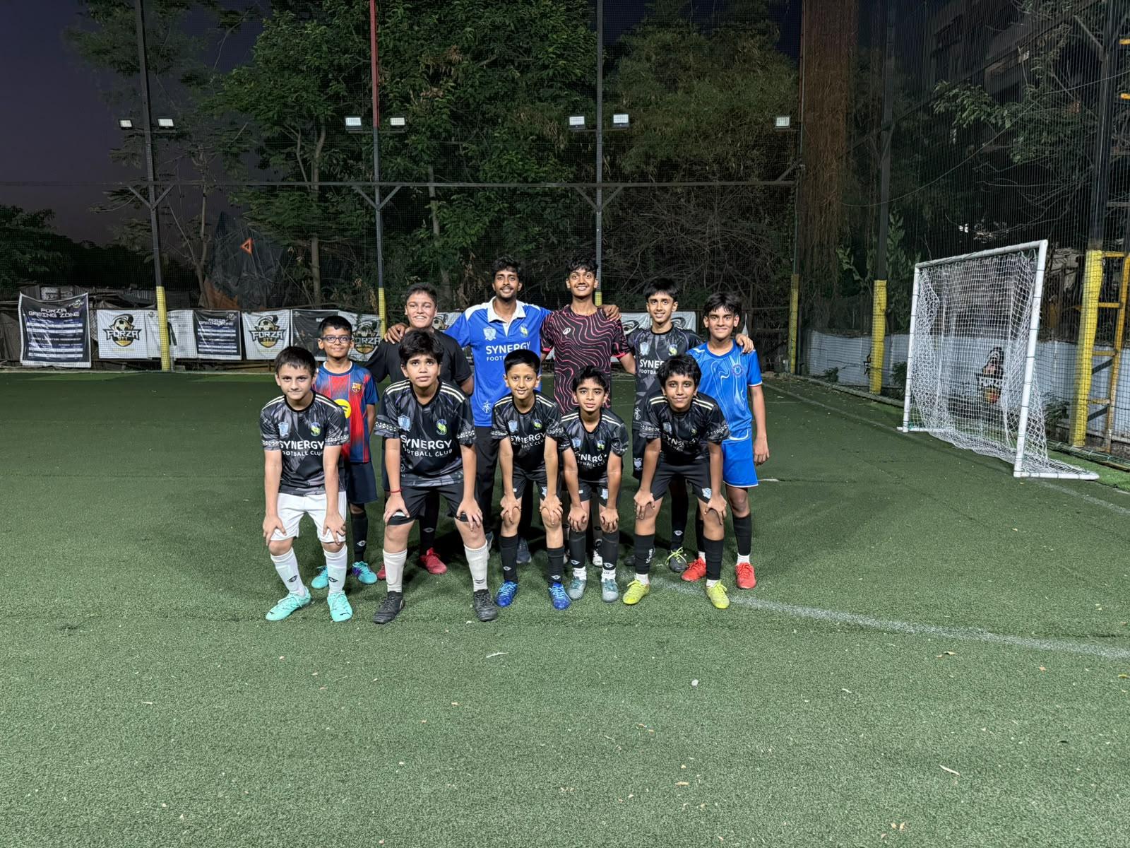 Synergy FC children together in club kit on the turf
